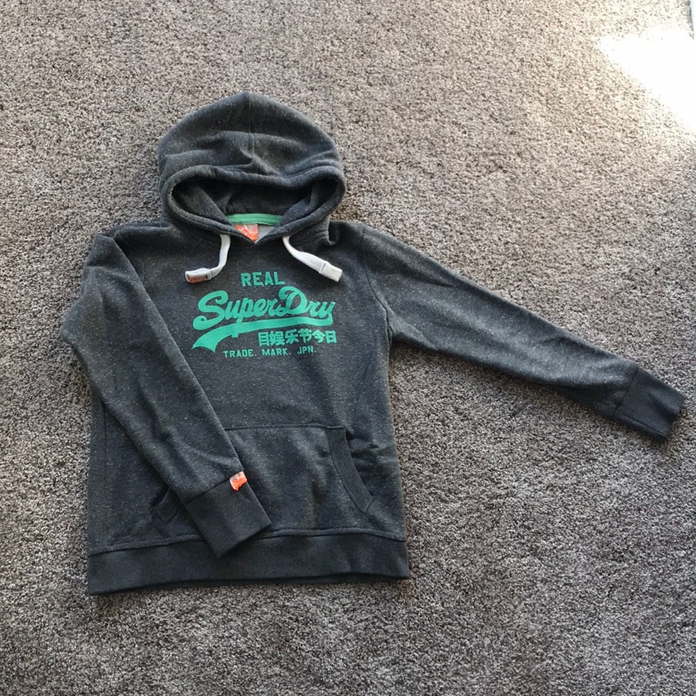 Grey superdry sweater with green writings on it